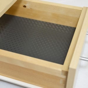 A wooden drawer with a black DIAMOND PLATE DESIGN and NON-SLIP MAT.