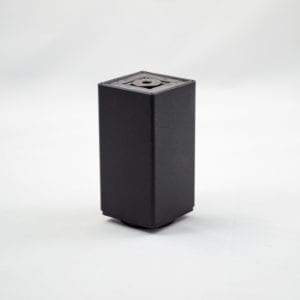 A black cube sitting on a white surface.