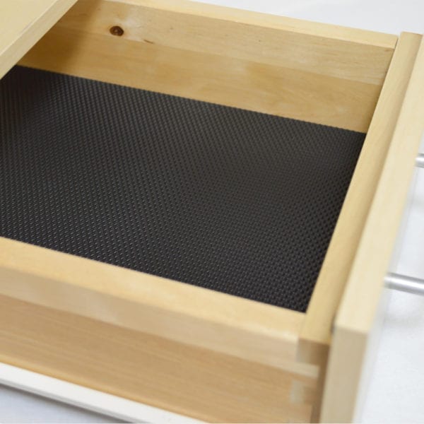 A wooden drawer with NON-SLIP SHEETS featuring PRISMA DESIGN.
