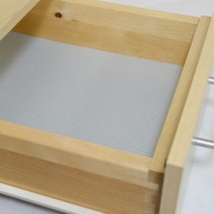 A drawer is open with a MODERN LINE DESIGN tray in it.