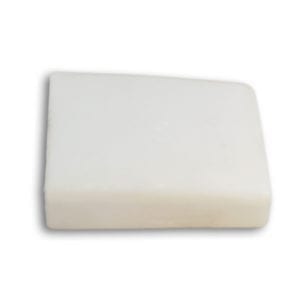 A white piece of soap on a white surface.