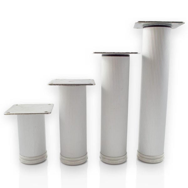 Four white pillars on a white surface.