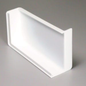 A white plastic shelf on a gray surface.