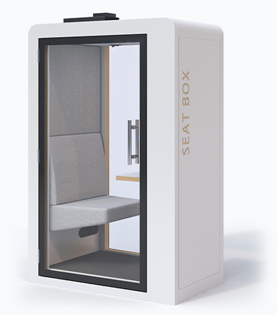 A compact meeting pod with a seat inside.