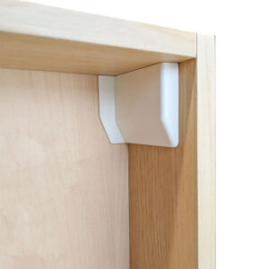 white cover cap concealing hardware in a cabinet