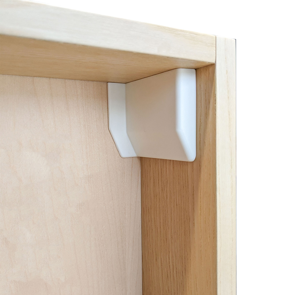 white cover cap concealing hardware in a cabinet